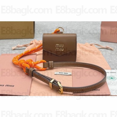 Miu Miu Leather, cord, and metal trick with mini-pouch bag 5TL515 Cognac/Orange 2024