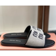 Miu Miu Canvas and leather slides Beige/black 5XX644 2025