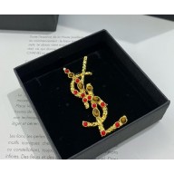 Saint Laurent CASSANDRE brooch in tiger's eye, sunstone, and metal ORANGE, RED AND GOLD 2025