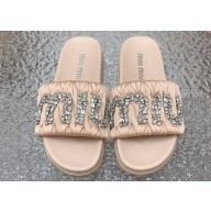 Miu Miu Matelassé Satin slides Beige with Crystal Logo 2024