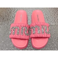 Miu Miu Matelassé nappa leather slides Pink with Crystal Logo 2024