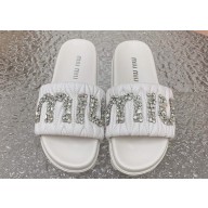 Miu Miu Matelassé nappa leather slides White with Crystal Logo 2024