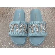 Miu Miu Matelassé nappa leather slides Blue with Crystal Logo 2024