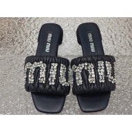 Miu Miu Matelassé nappa leather Heel slides Black with Crystal Logo 2024