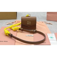 Miu Miu Leather, cord, and metal trick with mini-pouch bag 5TL515 Cognac/Yellow 2024