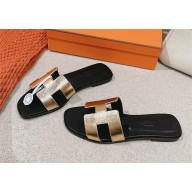 Hermes oran flat Sandals in swift leather gold/black 2025
