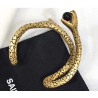 Saint Laurent Snake Bracelet In Gold Metal With A Black Glass Bead