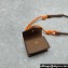 Miu Miu Leather, cord, and metal trick with mini-pouch bag 5TL515 Cognac/Orange 2024