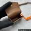 Miu Miu Leather, cord, and metal trick with mini-pouch bag 5TL515 Cognac/Orange 2024